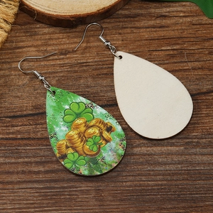 Detail view of teardrop wooden earrings with St. Patrick's clover and gold coin pattern