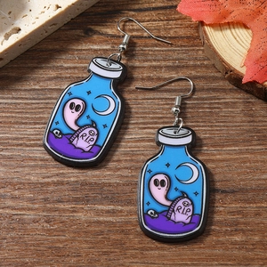 Macro view of acrylic Halloween potion bottle earrings with ghost and RIP tombstone