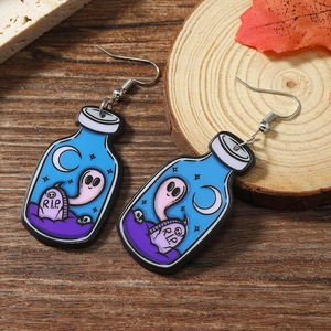 Detailed shot of acrylic Halloween earrings featuring ghost and R.I.P. tombstone designs