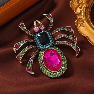 Pink oval crystal spider brooch with colorful rhinestones on vintage gold metal base
