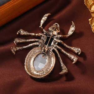 Vintage gold spider brooch with large pink oval crystal and intricate back detail
