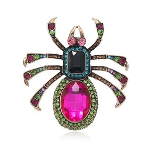 Vintage gold spider brooch with large pink oval crystal and colorful gemstone inlay