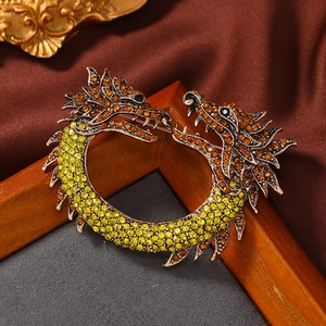 Vintage dragon brooch with yellow and orange crystals on bronze metal base