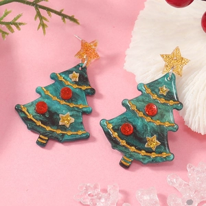 Detail of green resin Christmas tree earrings with gold glitter and star studs on festive background