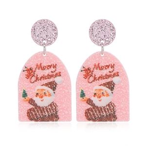 Close-up of pink Christmas tree earrings with Santa Claus and Merry Christmas text