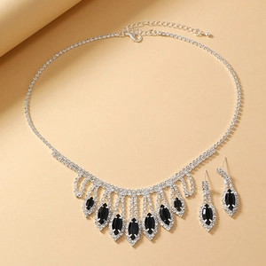 Close-up of bridal jewelry set with black marquise gems and silver fringe tassels