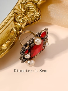 Detailed macro of vintage pearl cocktail ring with red crystal and 1.8cm diameter