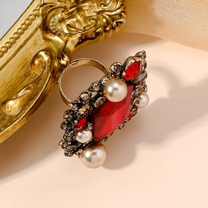 Vintage style gold ring featuring a large red crystal center stone and white pearls