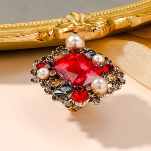 Baroque style ring with red rectangle gemstone and pearls on a vintage gold setting