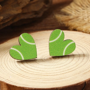 Detailed macro view of heart-shaped wooden stud earrings with green tennis ball flocking texture
