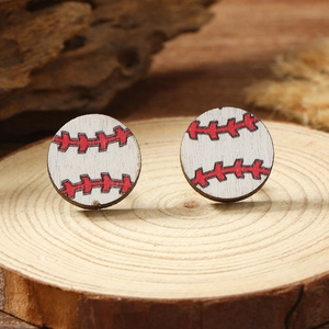 Macro shot of minimalist round wooden baseball stud earrings on natural wood base