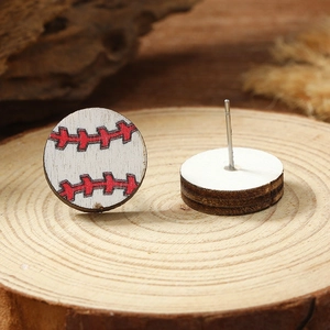 Macro shot of wooden baseball stud earrings with red stitching on natural wood base