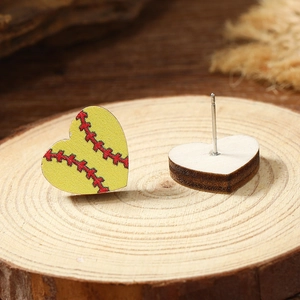 Close-up of yellow heart-shaped wooden softball earrings with red stitch pattern