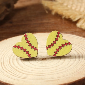 Macro detail of heart-shaped baseball stud earrings made of wood on a natural base