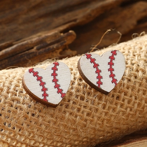 Detail of heart-shaped wooden baseball studs on rustic wood and burlap background