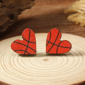 Minimalist heart-shaped wooden basketball stud earrings displayed on a rustic wood base