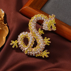 Luxurious dragon-shaped brooch with yellow and white rhinestones on gold metal base