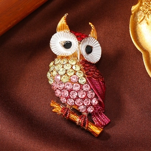 Exquisite owl brooch pin with colorful rhinestones on vintage brown silk background