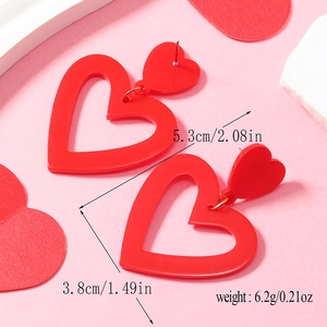 Detail shot of red heart acrylic drop earrings with dimensions 5.3cm length and 3.8cm width