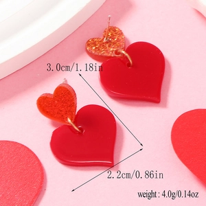Detail view of red heart earrings with glitter showing 3.0cm height and 2.2cm width