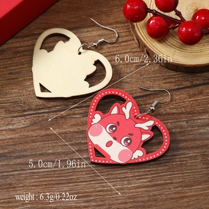 Detail view of heart-shaped wooden dragon earrings with dimensions and weight specs
