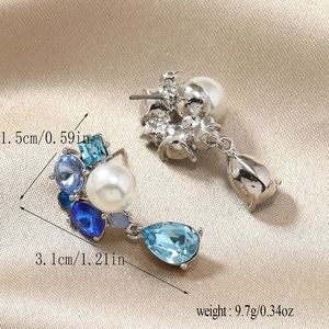Detail view showing blue crystal flower earrings with dimensions 3.1cm height and 1.5cm width