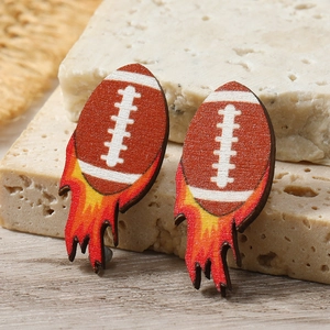 Macro detail of wooden rugby ball earrings with dynamic flame pattern on stone