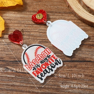 Detail of baseball theme acrylic earrings with red glitter heart and wood texture backdrop