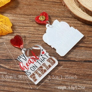 Macro detail of acrylic rugby earrings featuring leopard hearts and sport theme text