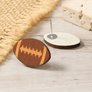 Detailed macro view of American football wooden stud earrings with back metal posts