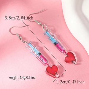 Detail view of pink acrylic syringe heart earrings with precise size measurement text