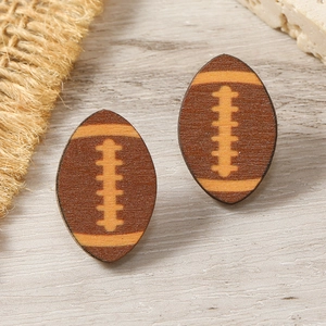 Macro shot of brown wooden American football stud earrings with yellow printed detailing
