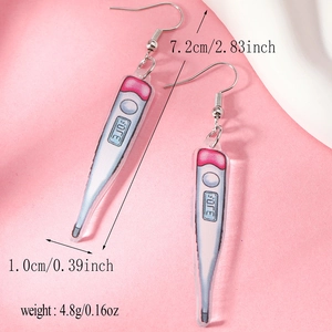 Detail shot of acrylic thermometer earrings with 7.2cm length and 4.8g weight specs