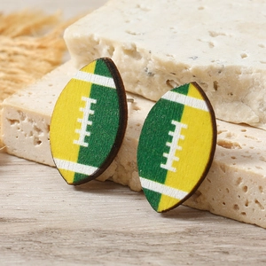Handcrafted yellow and green rugby wooden earrings on a textured stone background