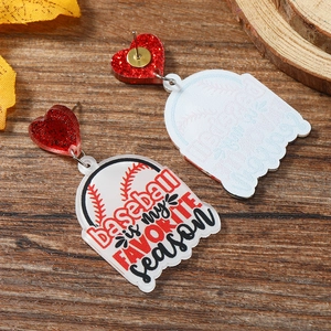 Detail of acrylic baseball earrings with red glitter heart and seasonal motif