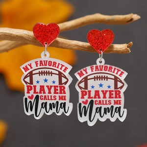 Detail view of football acrylic heart earrings with Mama text on a branch background