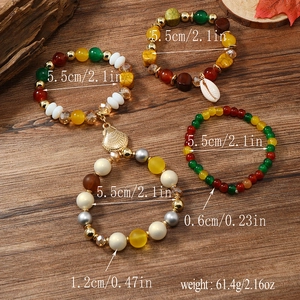 Detailaufnahme von mehrlagigen Boho-Perlenarmbändern mit Muschelanhänger und Maßangaben