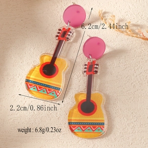 Detail view of colorful acrylic guitar earrings for Mexican Fiesta music festivals
