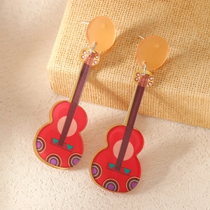 Colorful Mexican Fiesta guitar drop earrings with vibrant geometric patterns on yellow background