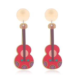 Close-up of red guitar-shaped earrings with colorful geometric patterns and gold studs