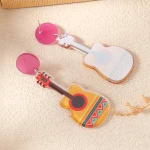 Detailed close-up of colorful acrylic guitar earrings with festive folk patterns