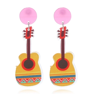 Close-up of vibrant yellow acrylic guitar earrings with ethnic patterns for festivals