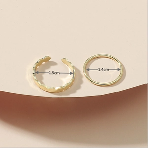 Detailed view of two gold rings with 1.5cm and 1.4cm diameter measurements shown