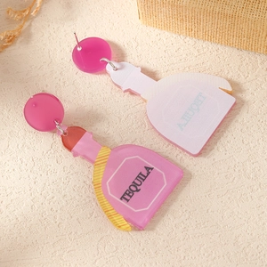 Detailed close-up of pink acrylic Tequila bottle earrings on a textured background