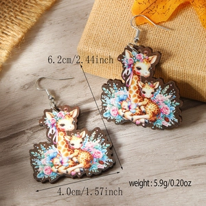 Detail view of colorful giraffe wooden earrings with floral patterns and measurements