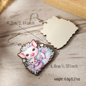 Detailed view of wood drop earrings with cute pig print and dimension specs