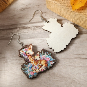 Artistic giraffe wooden earrings with floral painting on a light wood background