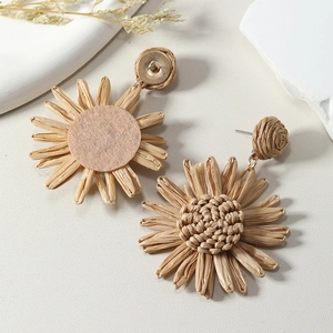 Detailed macro view of handmade raffia sunflower earrings with woven texture