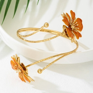 Gold-plated bamboo texture arm cuff featuring orange enamel flowers in a minimalist design