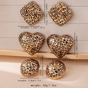 Close-up of leopard print earring set featuring square, heart, and round geometric shapes
